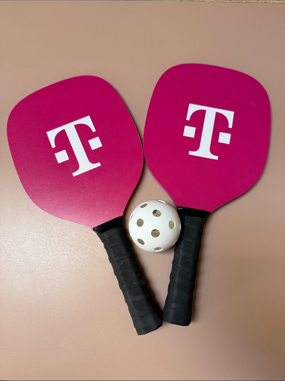 T‑Mobile Pink Pickleball Paddles with White Ball